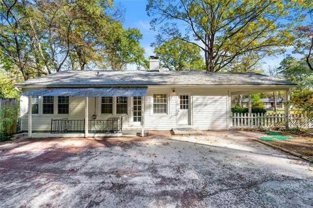 back of house with a carport