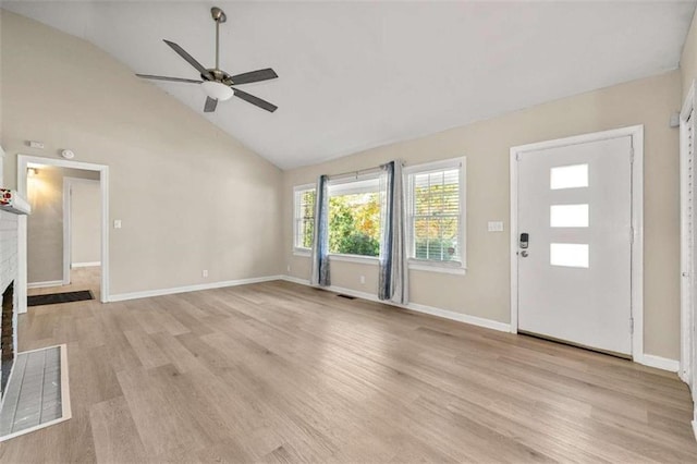 unfurnished living room featuring a brick fireplace, ceiling fan, high vaulted ceiling, and light hardwood / wood-style flooring