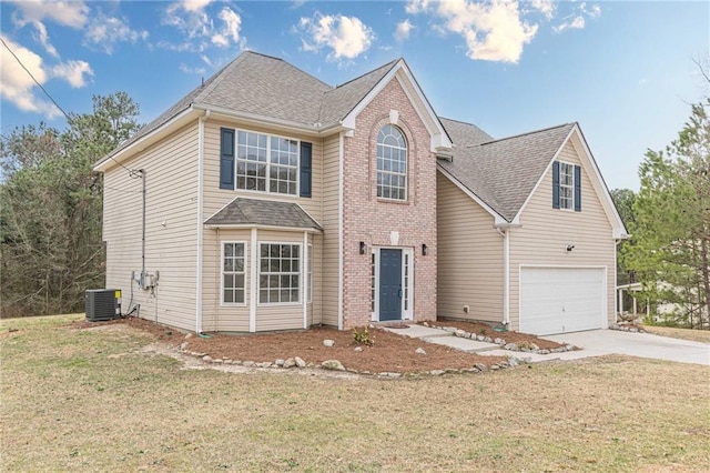 traditional home with a garage, central AC unit, concrete driveway, and a front yard