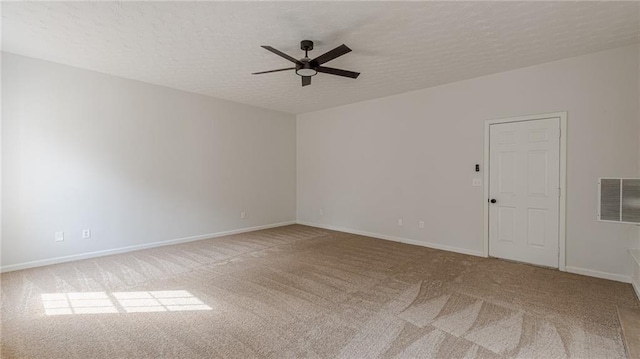 unfurnished room featuring baseboards, visible vents, a ceiling fan, a textured ceiling, and carpet flooring