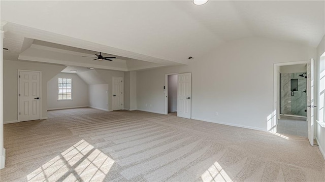 bonus room with light colored carpet, vaulted ceiling, baseboards, and ceiling fan