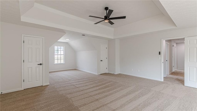 bonus room with carpet floors, baseboards, and a ceiling fan