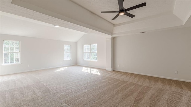 carpeted spare room featuring a textured ceiling, a tray ceiling, visible vents, and baseboards