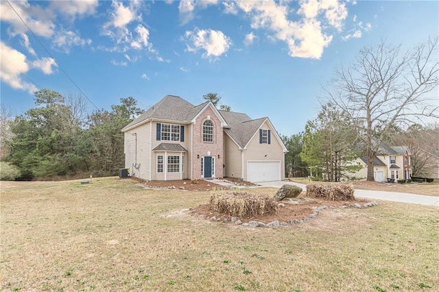 traditional-style home with a garage, a front yard, cooling unit, and driveway