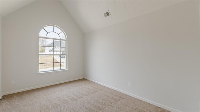 carpeted empty room with lofted ceiling, visible vents, and baseboards