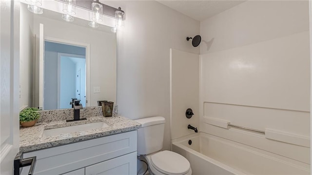 bathroom with tub / shower combination, vanity, and toilet