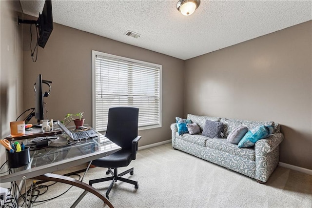 office with carpet and a textured ceiling