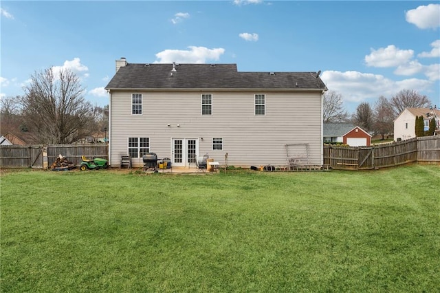 back of house featuring a patio and a lawn