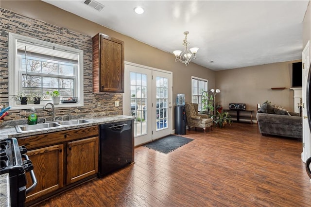 kitchen with dark wood-type flooring, sink, decorative backsplash, and black appliances