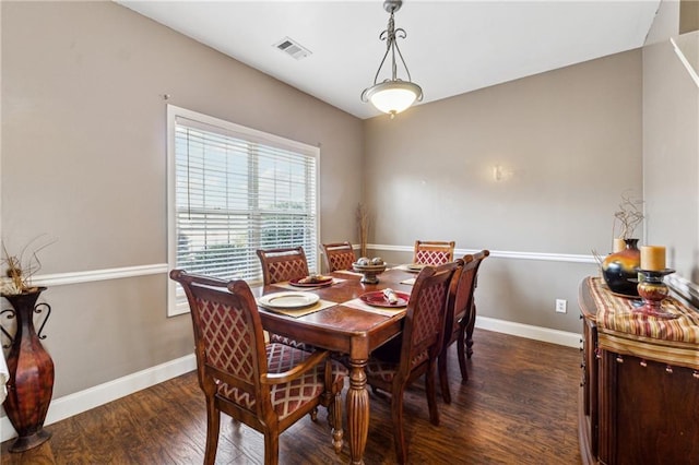 dining space with dark hardwood / wood-style flooring