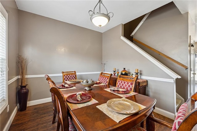 dining space featuring dark wood-type flooring