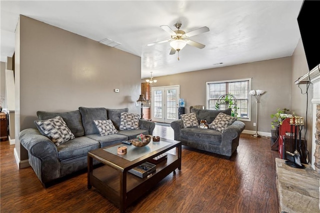 living room featuring a brick fireplace, ceiling fan with notable chandelier, and dark hardwood / wood-style flooring