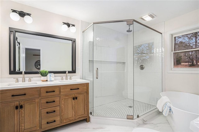 bathroom featuring vanity and shower with separate bathtub