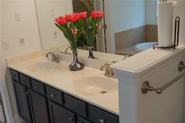 full bathroom with double vanity and a sink