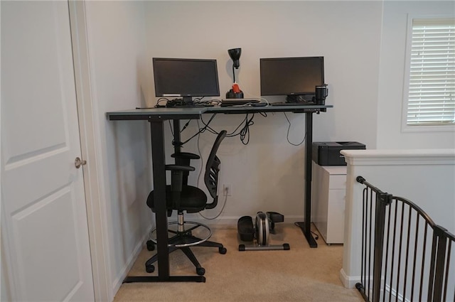 home office with light carpet and baseboards