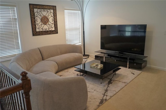 living area featuring carpet floors and baseboards