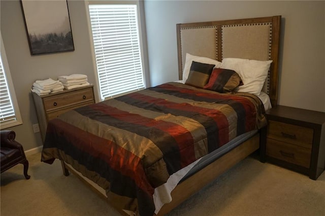 bedroom featuring light carpet