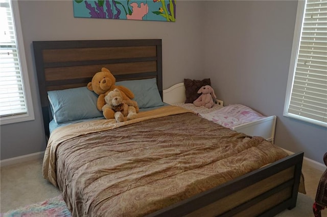 bedroom with carpet floors and baseboards