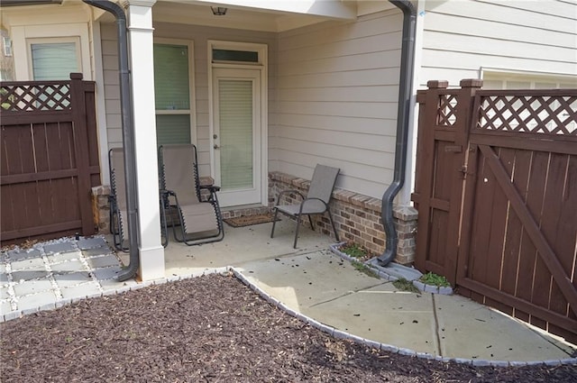 view of exterior entry with a gate and fence