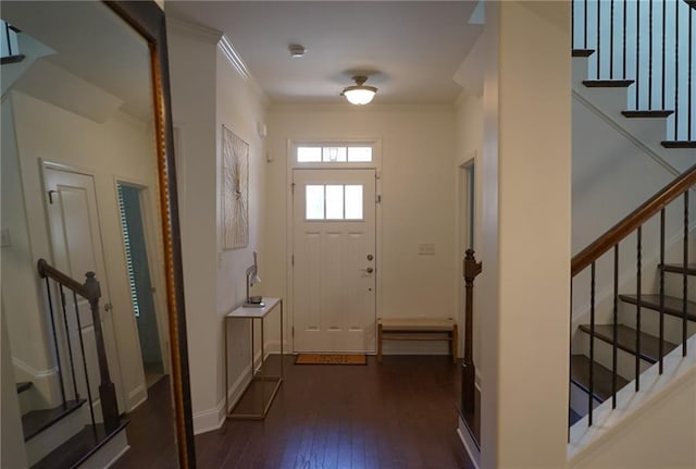 entryway with ornamental molding, stairway, dark wood finished floors, and baseboards