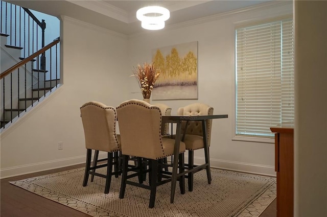 dining space featuring stairway, baseboards, crown molding, and wood finished floors