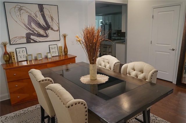 dining space featuring dark wood-style flooring