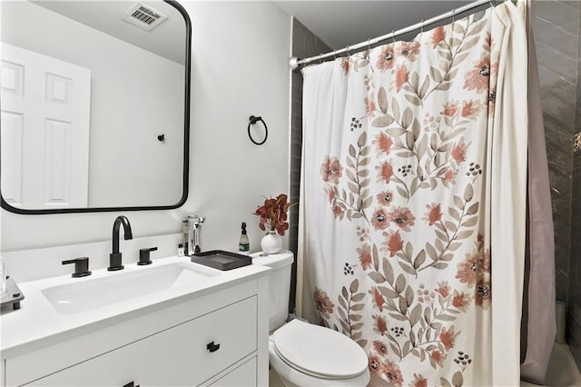 bathroom with vanity, a shower with shower curtain, and toilet