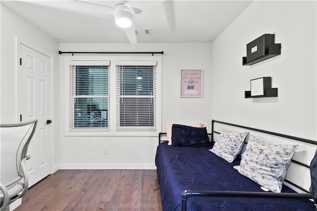 bedroom with ceiling fan and dark hardwood / wood-style floors