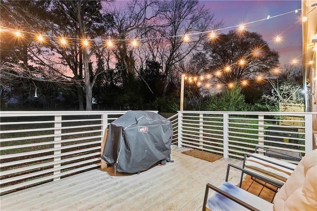 deck at dusk with grilling area