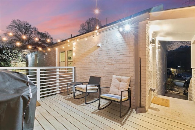 deck at dusk with grilling area