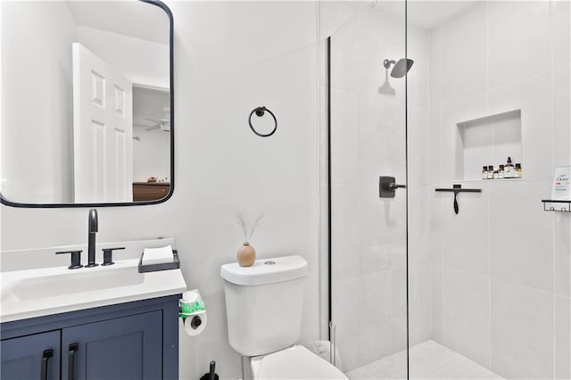 bathroom with vanity, toilet, and a shower with shower door