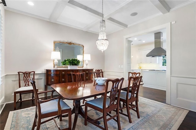 dining room with beam ceiling, coffered ceiling, and wood finished floors