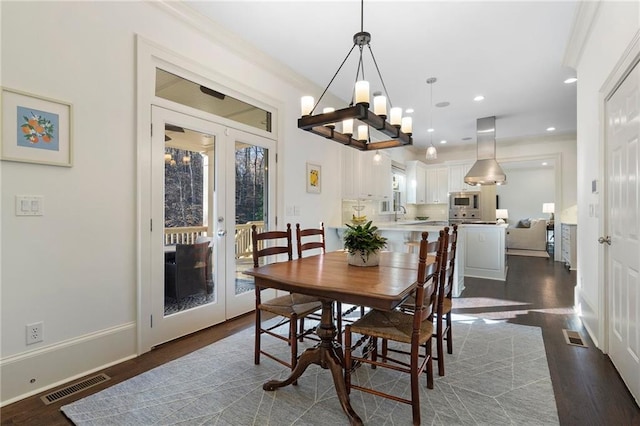 dining area featuring visible vents, baseboards, dark wood finished floors, and french doors