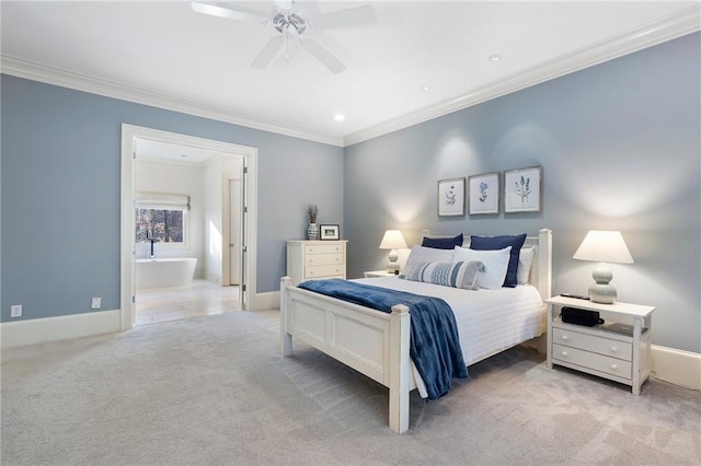 bedroom with baseboards, light colored carpet, ensuite bath, and crown molding