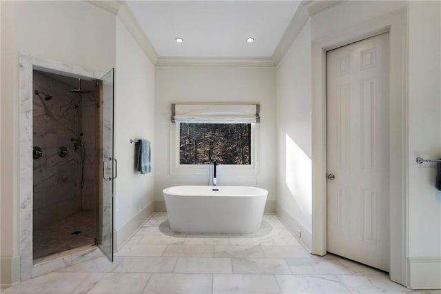 full bath with a freestanding tub, marble finish floor, ornamental molding, a marble finish shower, and baseboards