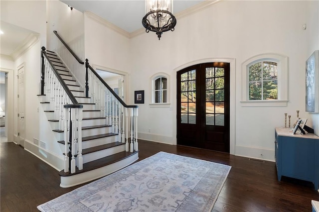 entrance foyer featuring baseboards, french doors, dark wood-style flooring, and ornamental molding