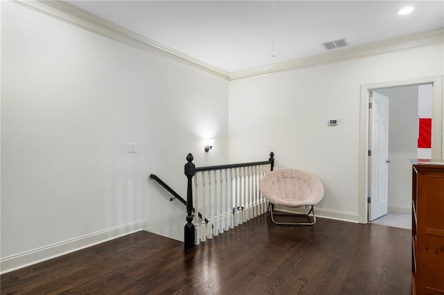 stairs featuring crown molding, wood finished floors, visible vents, and baseboards