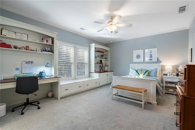 bedroom featuring visible vents, light colored carpet, built in study area, and crown molding