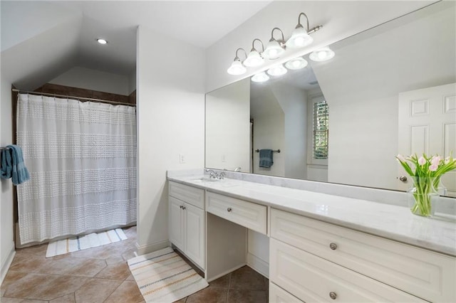 bathroom featuring tile patterned flooring, vanity, a shower with shower curtain, and lofted ceiling