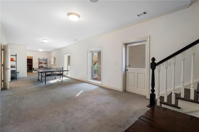 rec room with carpet flooring, visible vents, crown molding, and baseboards