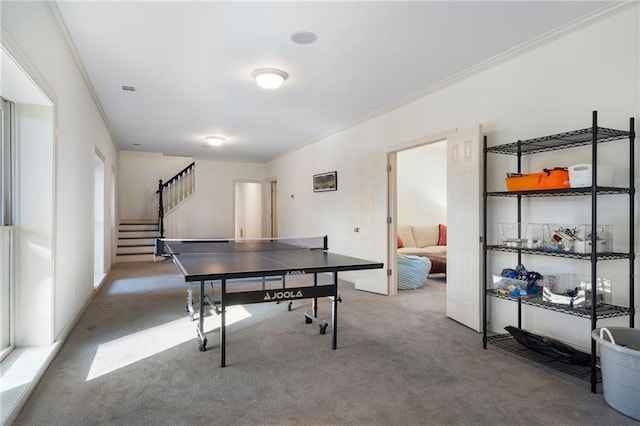 playroom with carpet floors and crown molding