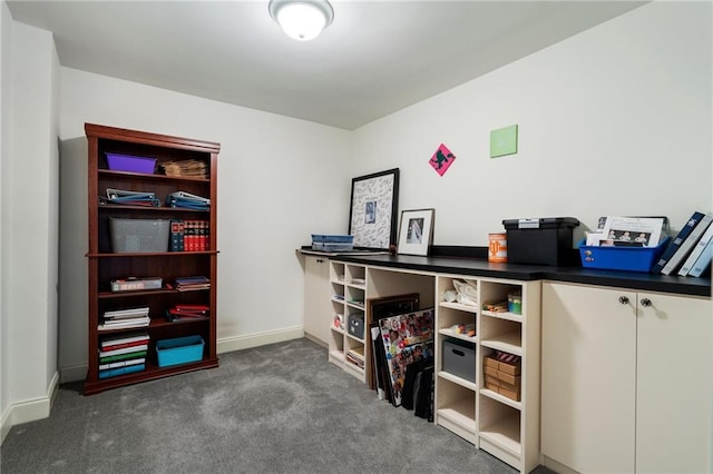 carpeted office space featuring baseboards