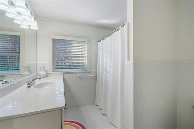 full bathroom featuring vanity, crown molding, and curtained shower