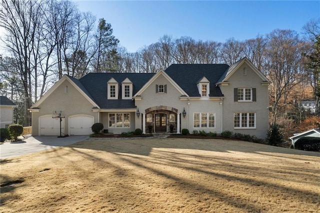 view of front of home featuring french doors, concrete driveway, and an attached garage