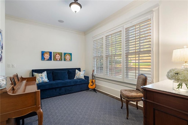 living area featuring wood finished floors, baseboards, and ornamental molding