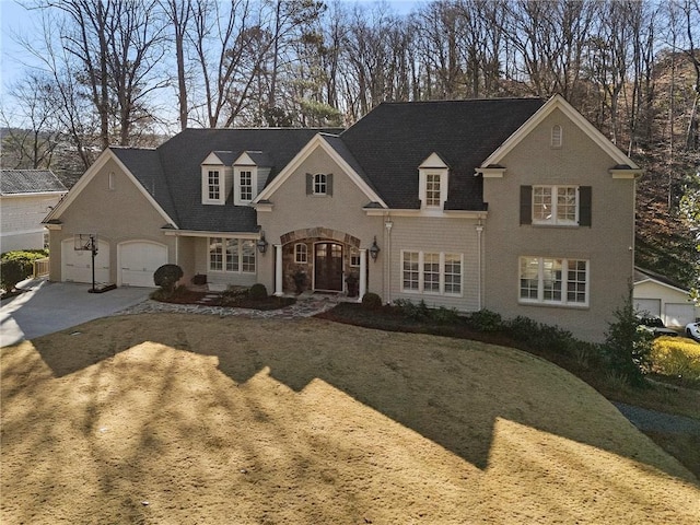 view of front facade featuring brick siding, driveway, and a garage