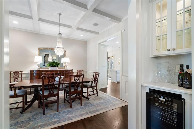 dining space with beam ceiling, coffered ceiling, beverage cooler, and dark wood finished floors