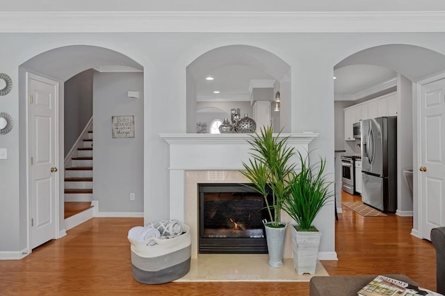 living room with hardwood / wood-style floors and crown molding