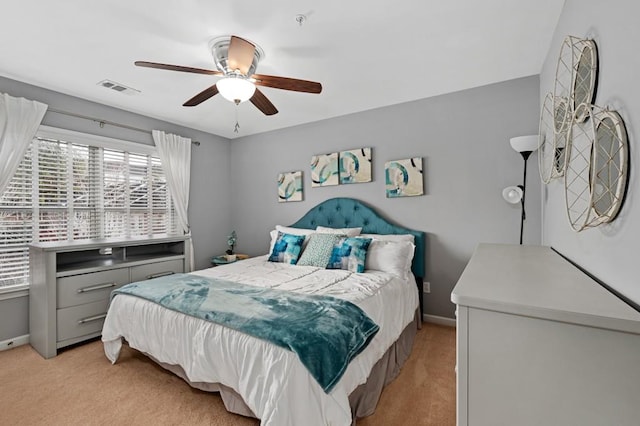 bedroom with light carpet and ceiling fan