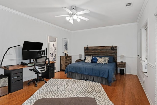 bedroom featuring crown molding, ceiling fan, and hardwood / wood-style floors